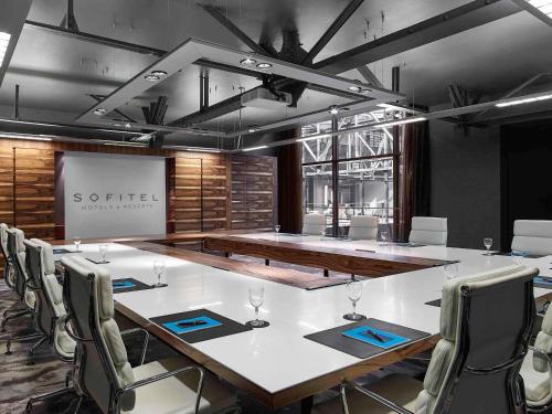 a conference room with a long table and chairs at Sofitel Munich Bayerpost in Munich