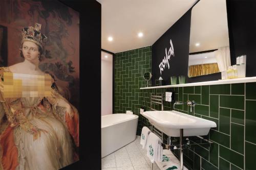a bathroom with a sink and a painting of a woman at nhow London in London