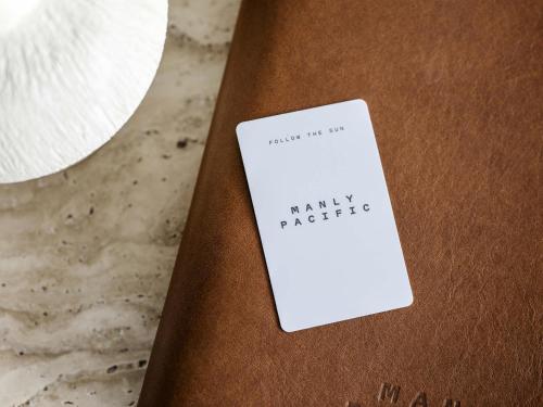 a white card sitting on top of a book at Manly Pacific Sydney MGallery Collection in Sydney