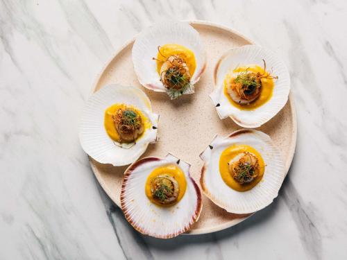 a plate of food with five food dishes on it at Manly Pacific Sydney MGallery Collection in Sydney