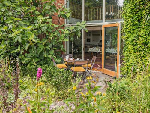 a patio with a table and chairs in a garden at 2 Bed in Kington 92986 in Lyonshall