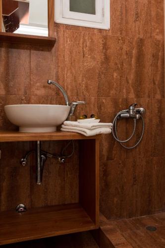 a bathroom with a sink and a mirror at Miltiadis Apartments in Ambelas