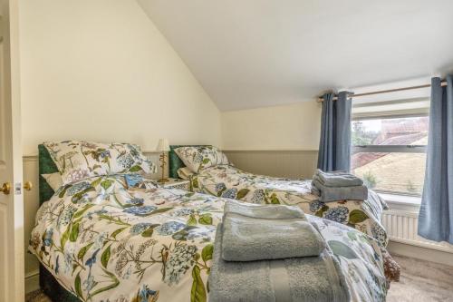 a bedroom with a bed and a window at The Anchorage - Snettisham in Snettisham