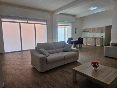 a living room with a couch and a table at Elysium Affittacamere in Mazara del Vallo