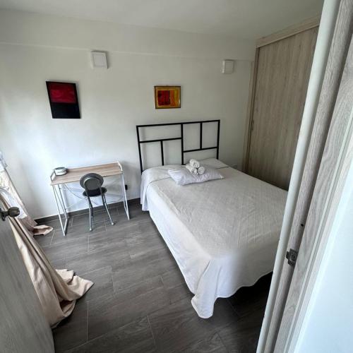 a bedroom with a bed and a small table at APTO EN NORTE DE ARMENIA in Armenia