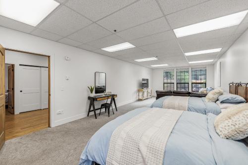 a bedroom with two beds and a desk in it at The Loft- Steps from the Lake & Dining- This newly renovated 2 bedroom loft in the heart of McCall in McCall