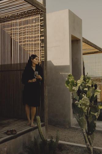 a woman is standing in front of a mirror at Casa Michaus Valle de Guadalupe in Valle de Guadalupe