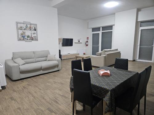 a living room with a table and a couch at Elysium Affittacamere in Mazara del Vallo