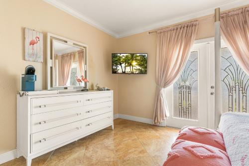 a bedroom with a dresser and a mirror at Paradise in Time in Port Saint Lucie