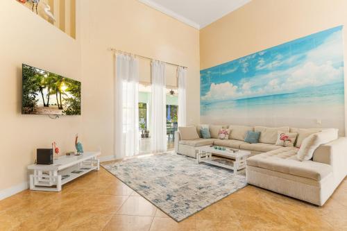 a living room with a couch and a table at Paradise in Time in Port Saint Lucie