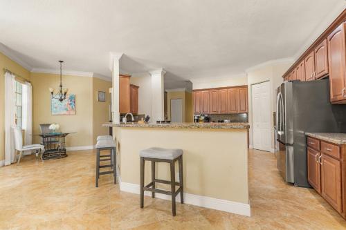 a kitchen with a refrigerator and a counter top at Paradise in Time in Port Saint Lucie