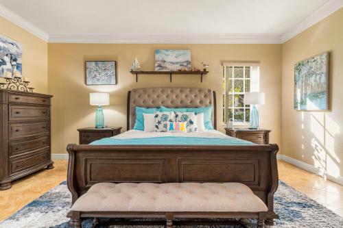 a bedroom with a large bed with a wooden frame at Paradise in Time in Port Saint Lucie