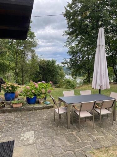 a table and chairs with an umbrella and a table at Wanderer Paradies in Pirna