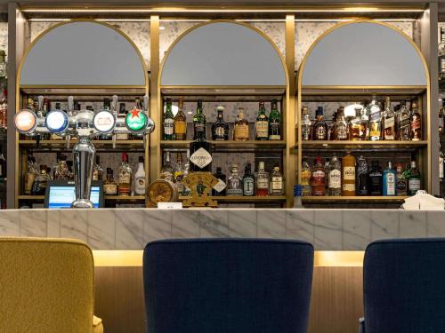 a bar with a lot of bottles of alcohol at Sofitel Dubai Jumeirah Beach in Dubai