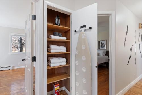 a room with a closet with towels and a mirror at High-End Finger Lakes Escape - Expansive Game Room, Cozy Firepit, & Scenic Views in Penn Yan