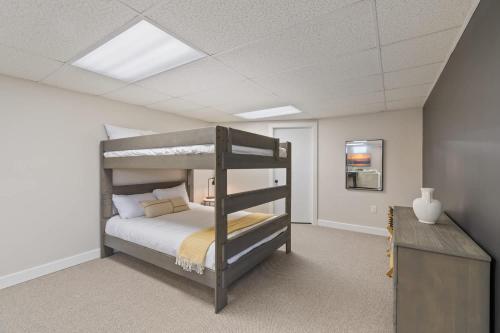 a bedroom with a bunk bed and a desk at High-End Finger Lakes Escape - Expansive Game Room, Cozy Firepit, & Scenic Views in Penn Yan