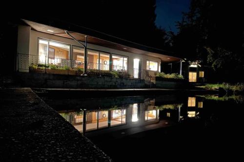 a house at night with its lights on at Unique Waterfront Cottage 34 Mi To Mt Rainier in Eatonville