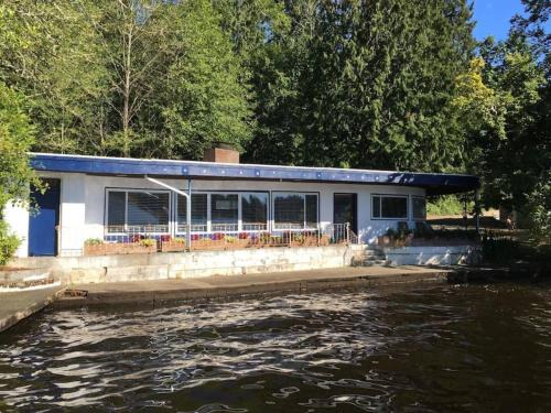 a house on the side of a body of water at Unique Waterfront Cottage 34 Mi To Mt Rainier in Eatonville