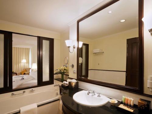 a bathroom with a sink and a large mirror at Sofitel Krabi Phokeethra Golf and Spa Resort in Klong Muang Beach