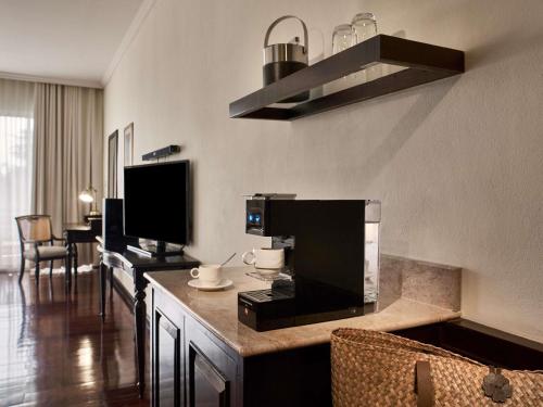 a hotel room with a coffee machine on a counter at Sofitel Krabi Phokeethra Golf and Spa Resort in Klong Muang Beach