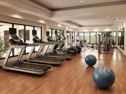 a gym with a row of treadmills and exercise machines at Sofitel Krabi Phokeethra Golf and Spa Resort in Klong Muang Beach