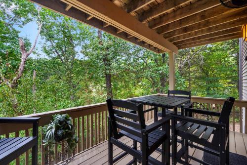a porch with a table and chairs on a deck at Top Notch - Condo for 6 in Branson