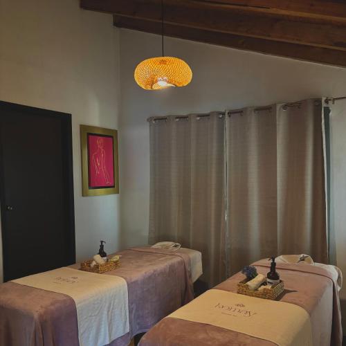 a room with two beds and a light at Hotel Villas Mariposas in Atlixco