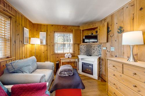 a living room with a couch and a fireplace at Hidden Villa Cottage #1 - The Nautical Cottage in Cannon Beach