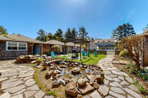 a backyard with a rock garden with a pond at Hidden Villa Cottage #1 - The Nautical Cottage in Cannon Beach