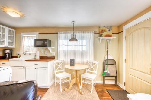 a kitchen with a table and chairs in a room at Hidden Villa Cottage #5 - The Sunflower Cottage in Cannon Beach