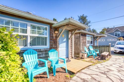 a group of blue chairs sitting on the front porch of a house at Hidden Villa Cottage #5 - The Sunflower Cottage in Cannon Beach