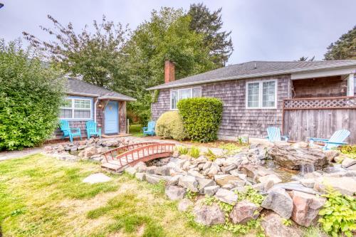 a home with a rock garden and a pond at Hidden Villa Cottage #5 - The Sunflower Cottage in Cannon Beach