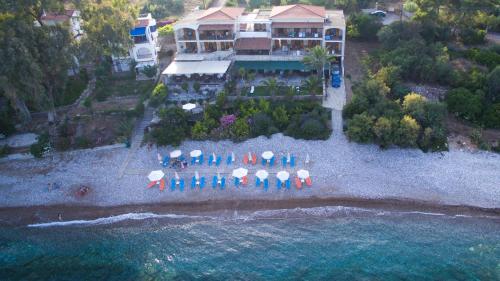 an aerial view of a house on a beach with umbrellas at Grekis Beach Hotel and Apartments in Petalidhion