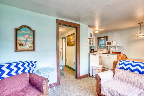 a living room with a couch and a table at Hidden Villa Cottage #4 - The Ocean Cottage in Cannon Beach