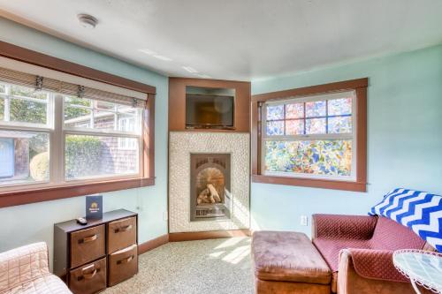 a living room with a couch and a fireplace at Hidden Villa Cottage #4 - The Ocean Cottage in Cannon Beach