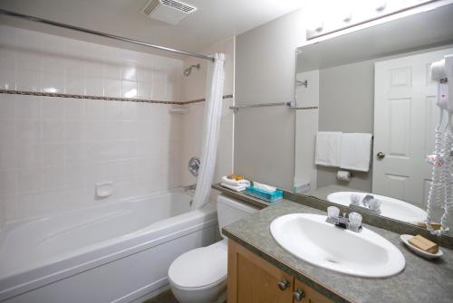 a bathroom with a sink and a toilet and a tub at Panorama Vacation Retreat at Horsethief Lodge in Panorama