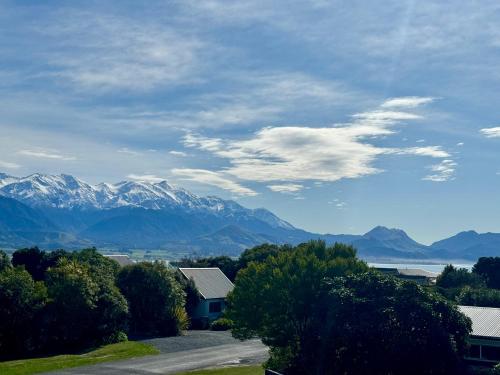 a view of a mountain range with a house and trees at Austin Heights - Kaikoura in Kaikoura