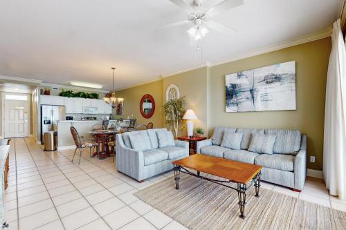 a living room with two couches and a table at Regency Isle 903 in Perdido Key