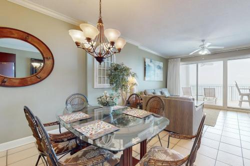 a dining room with a glass table and chairs at Regency Isle 903 in Perdido Key