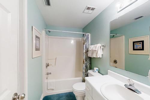 Un baño con lavabo, inodoro y ducha. en Tidewater 608, en Orange Beach