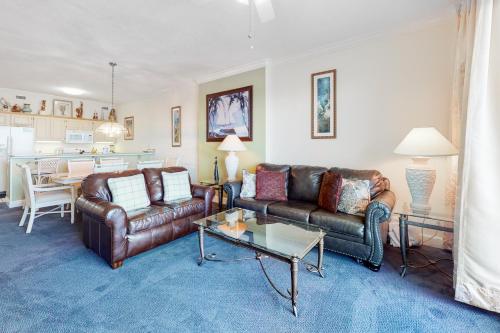 a living room with two leather couches and a table at Regency Isle 805 in Perdido Key