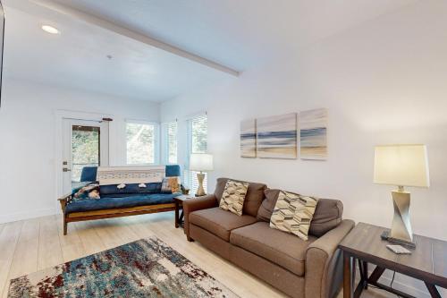 a living room with a couch and a table at Serenity at Deerhaven #B in Gold Beach