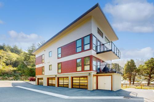 a house with a red and white building at Serenity at Deerhaven #B in Gold Beach