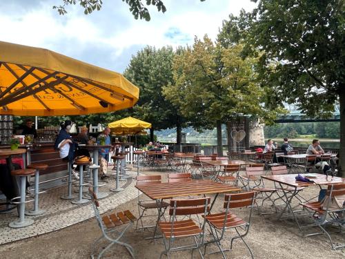 a restaurant with tables and chairs and people sitting at tables at Boutique Hotel am Schillerplatz in Dresden