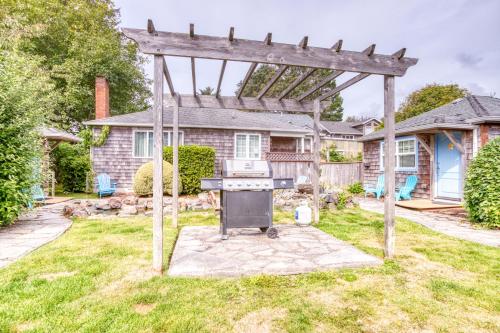a grill in the yard of a house at Hidden Villa Cottage #6 - The Starfish Cottage in Cannon Beach