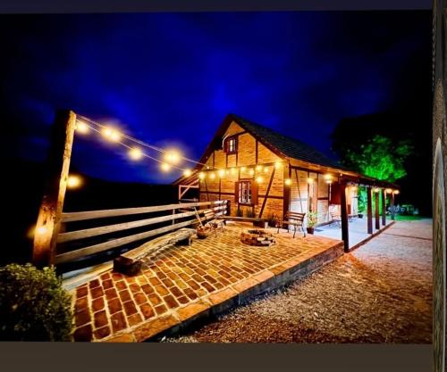 a house with lights on the side of it at Recanto Nascer do Sol in Nova Petrópolis