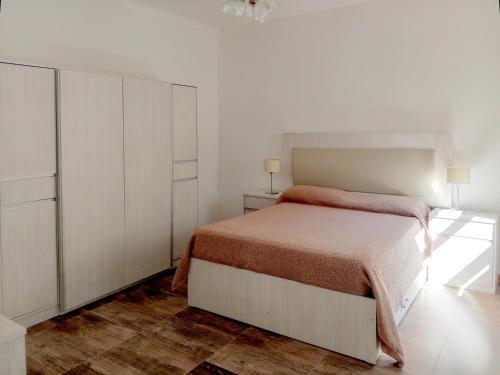 a white bedroom with a bed and a dresser at Casa Avellaneda in Santa Fe