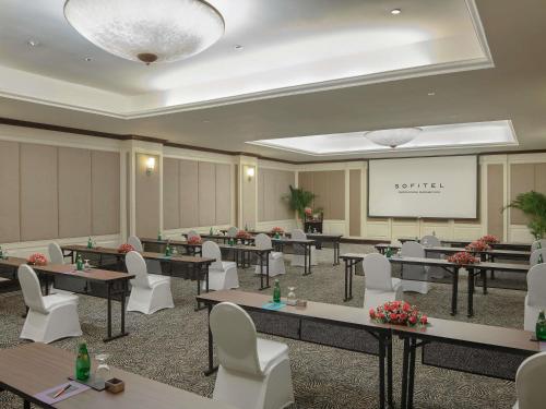a conference room with tables and chairs and a whiteboard at Sofitel Phnom Penh Phokeethra in Phnom Penh