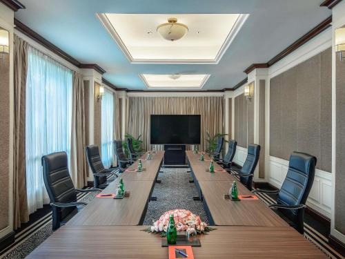 a large conference room with a long table and chairs at Sofitel Phnom Penh Phokeethra in Phnom Penh