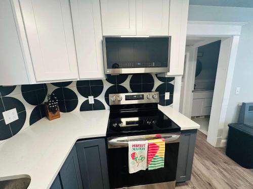 a kitchen with a stove and a microwave at Rink Side Retreat in Grand Rapids